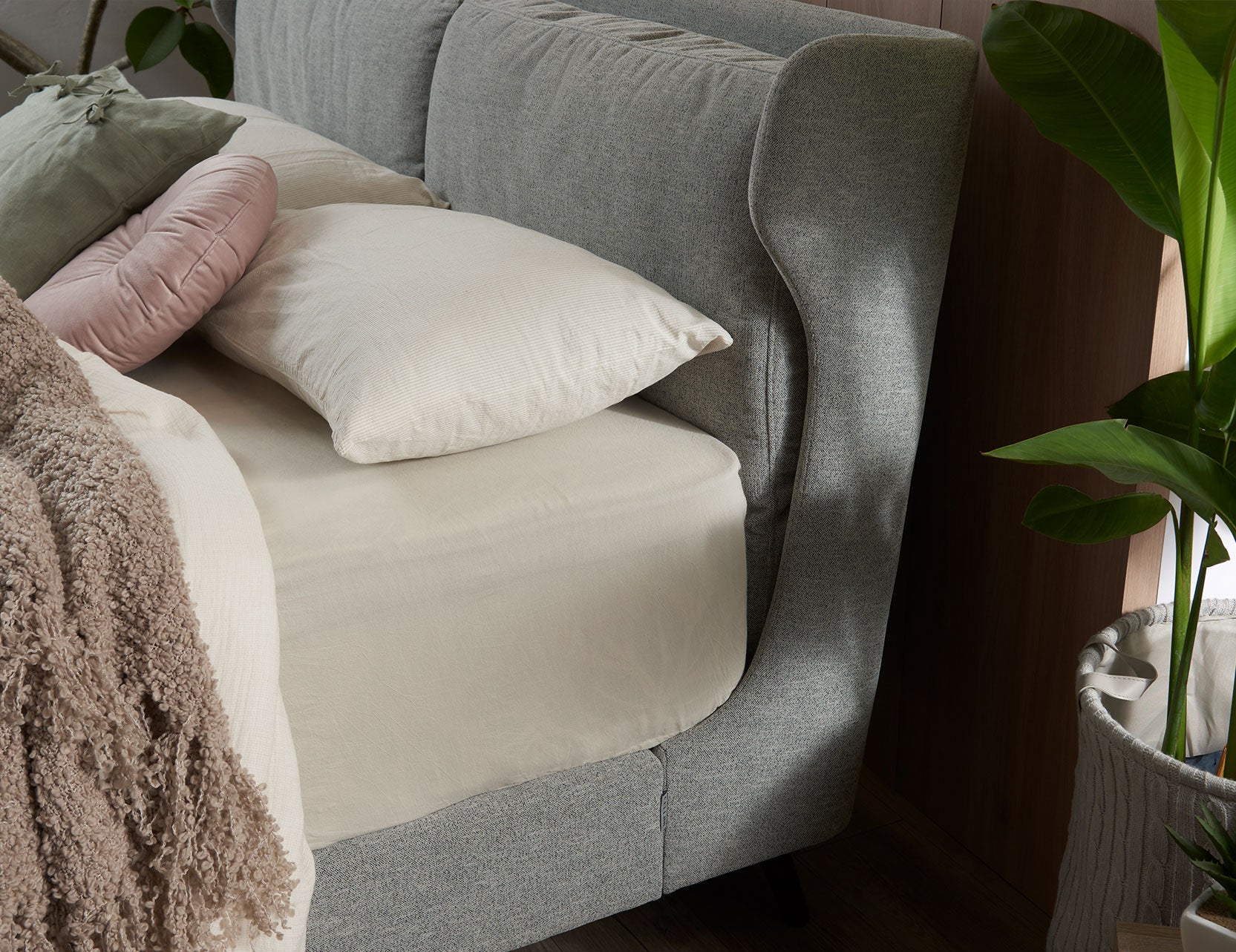 Winged bed frame with upholstered side panels