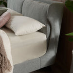 Winged bed frame with upholstered side panels