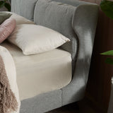 Winged bed frame with upholstered side panels