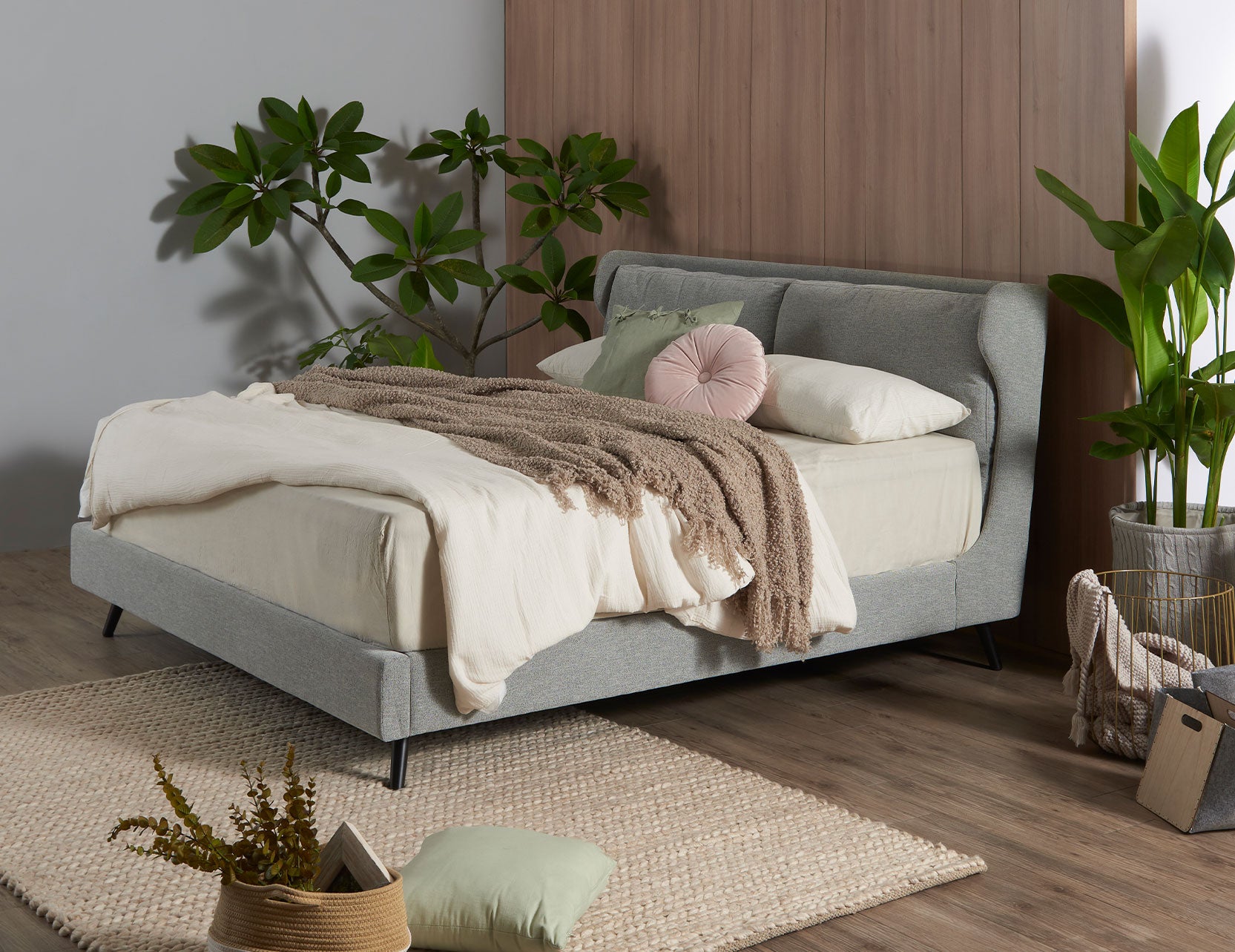Winged bed frame with upholstered side panels