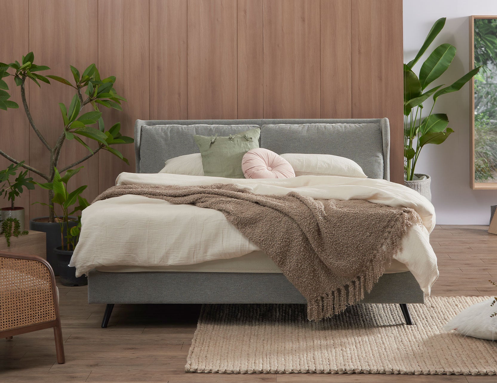 Winged bed frame displayed from a wider angle