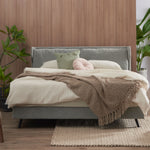 Winged bed frame displayed from a wider angle