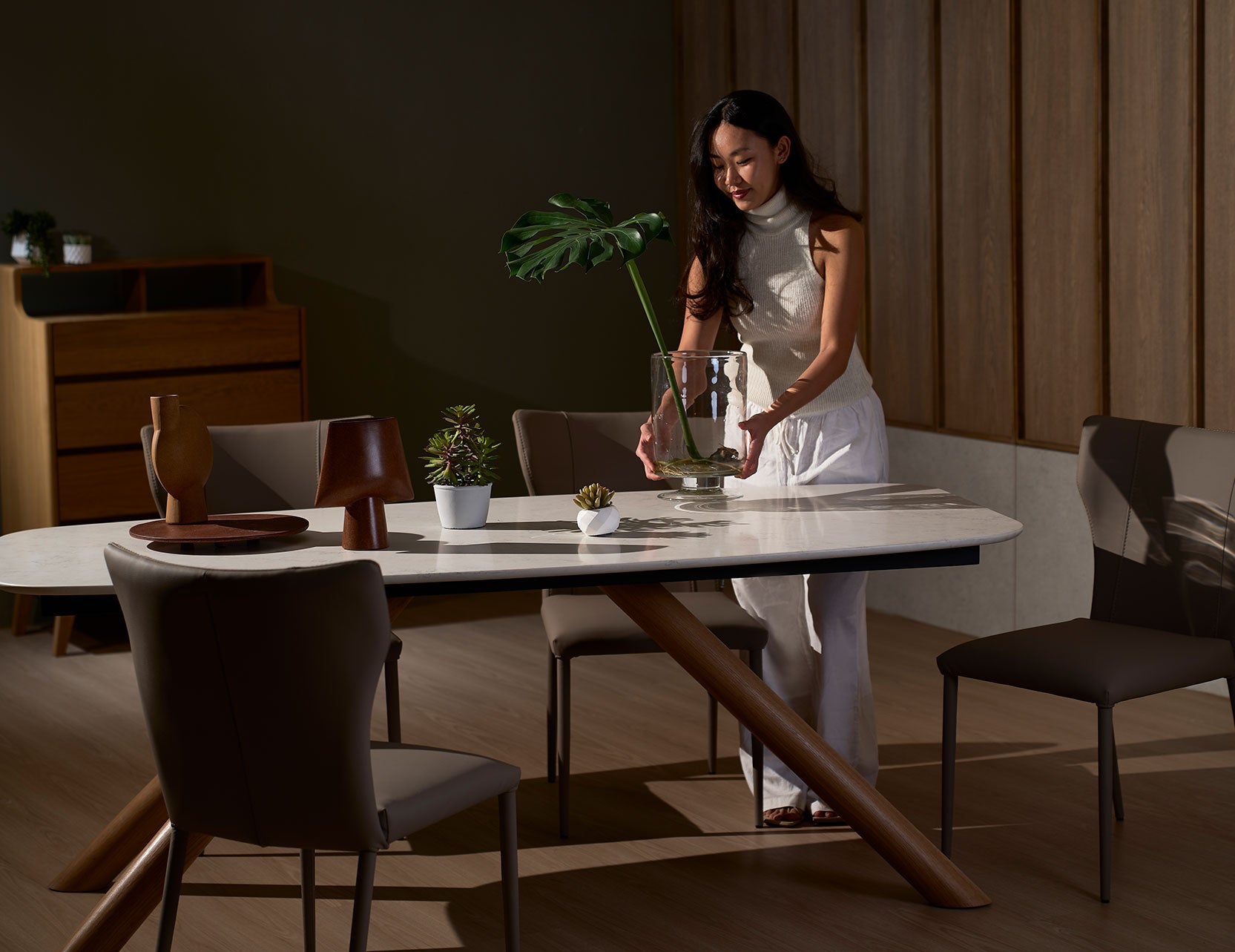 Branca foil dining table shown with model for scale