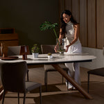 Branca foil dining table shown with model for scale