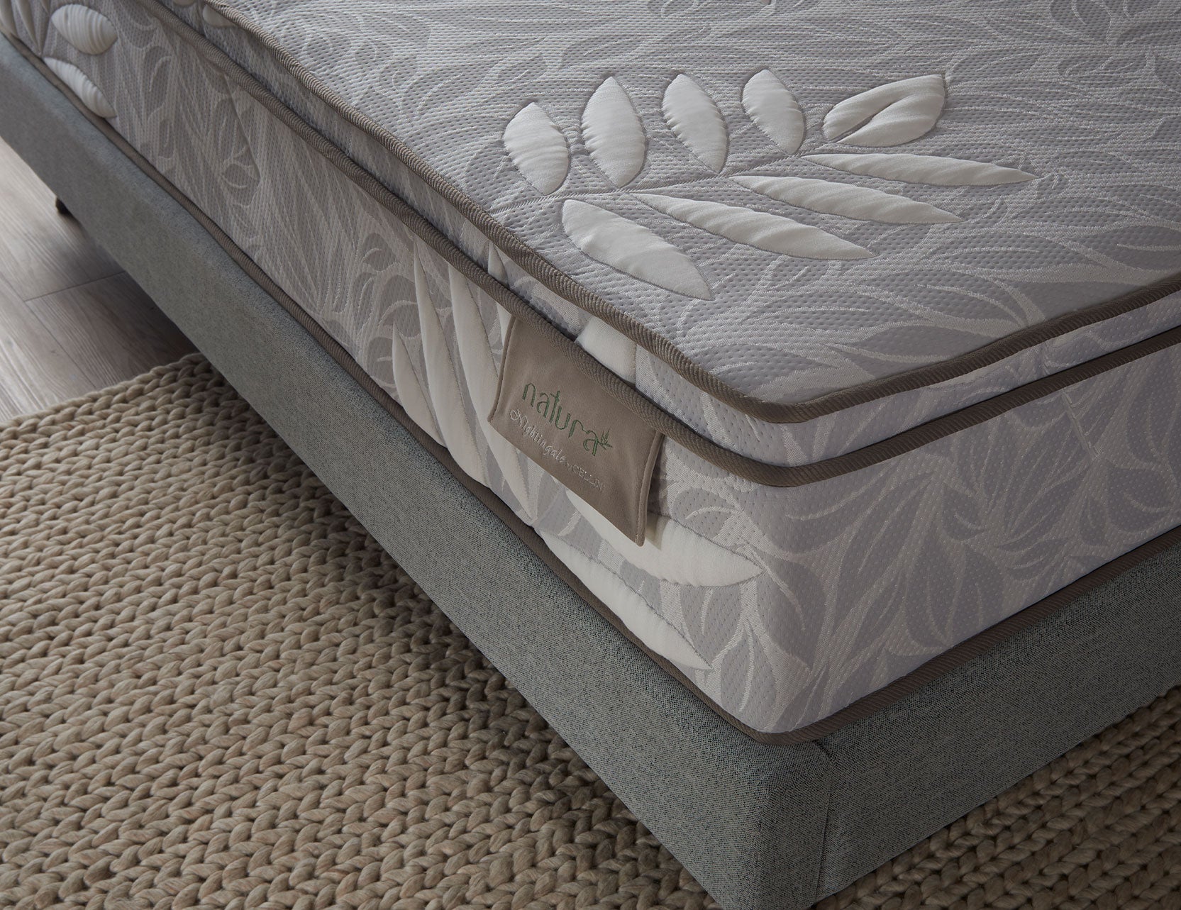 Natura mattress shown in a full bedroom setup
