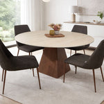 Round dining table with wooden base and four upholstered chairs in modern space