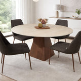 Round dining table with wooden base and four upholstered chairs in modern space