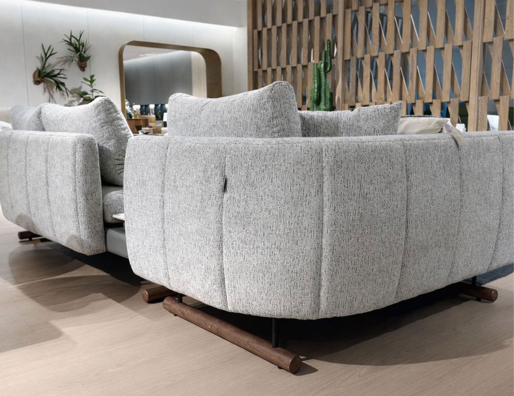 Curved fabric sofa set with textured upholstery in contemporary showroom