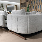 Curved fabric sofa set with textured upholstery in contemporary showroom