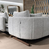 Curved fabric sofa set with textured upholstery in contemporary showroom